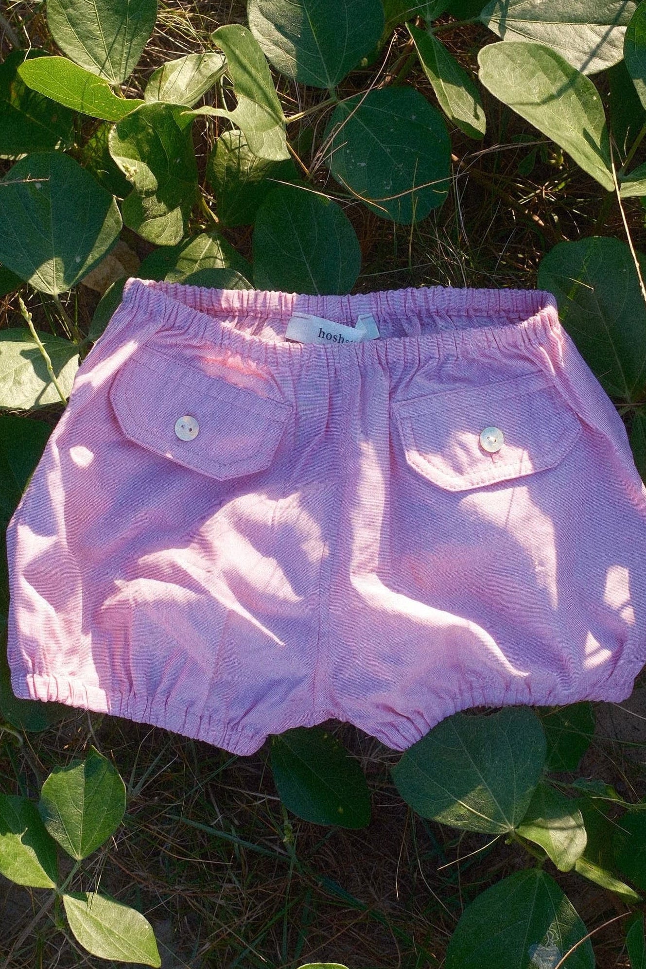 Purple diaper on green leaves