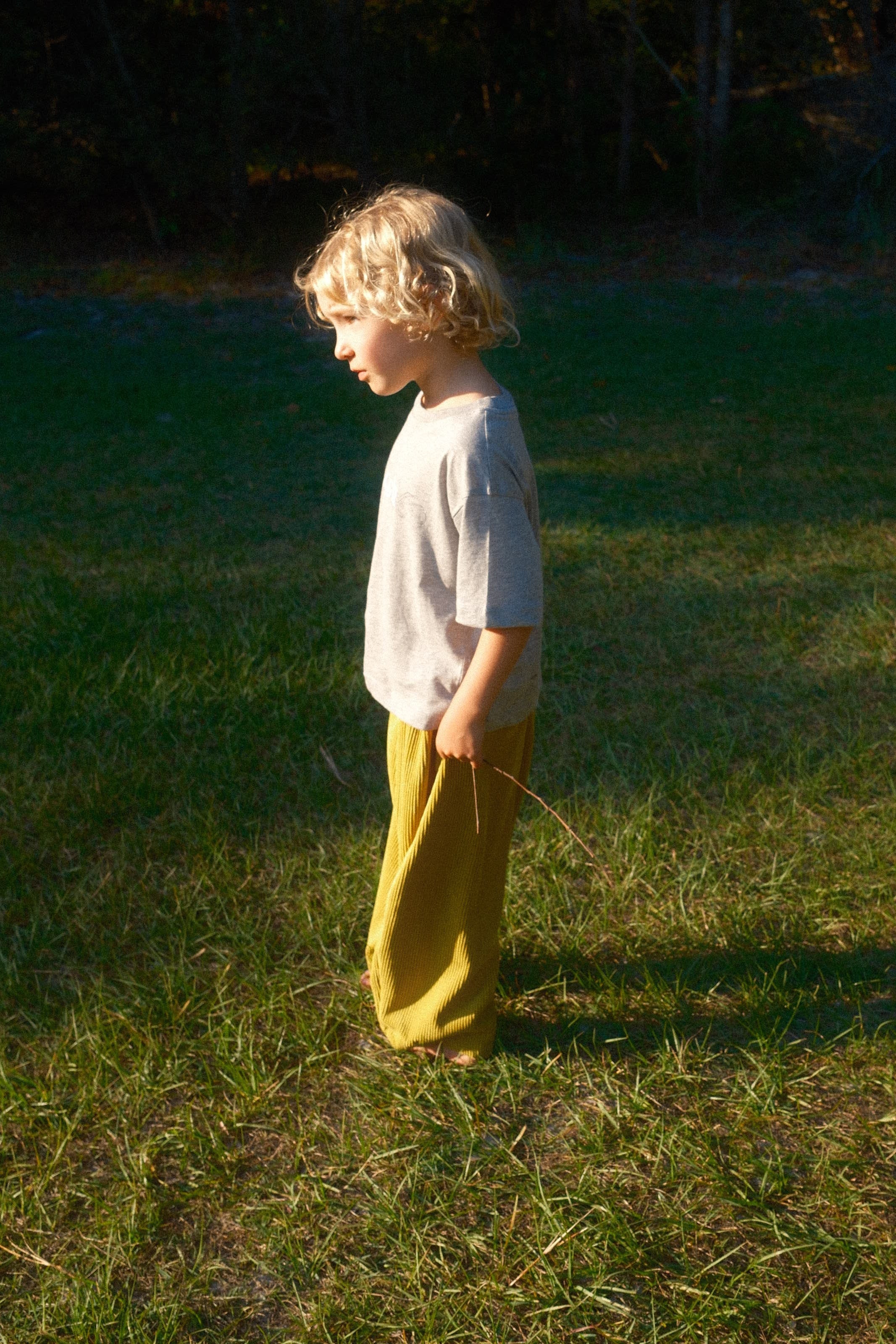 Person lying on grass with a yellow garment