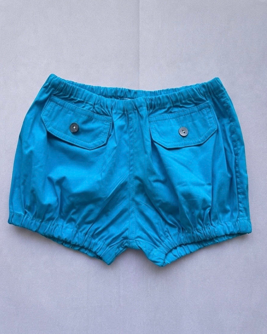 Blue shorts with two pockets on a light gray background